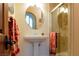 Elegant bathroom with a pedestal sink, decorative mirror, and glass-enclosed shower at 8120 W Red Coach Ave, Las Vegas, NV 89129
