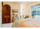 Bright bedroom with colorful accents, a unique dresser, and a large window offering natural light at 8120 W Red Coach Ave, Las Vegas, NV 89129