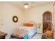 Bright bedroom with white furniture, colorful accents, and a window offering natural light at 8120 W Red Coach Ave, Las Vegas, NV 89129