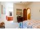 Bright bedroom featuring an archway, patterned bedding, and a stylish table with decorative items at 8120 W Red Coach Ave, Las Vegas, NV 89129