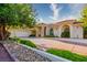Stunning home with a three-car garage, landscaped front yard, and circular driveway at 8120 W Red Coach Ave, Las Vegas, NV 89129