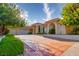 Spacious home with a three car garage and beautifully maintained landscaping enhances curb appeal at 8120 W Red Coach Ave, Las Vegas, NV 89129
