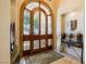 Elegant foyer with a custom wood door and intricate details at 8120 W Red Coach Ave, Las Vegas, NV 89129