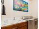 Functional laundry area with tile countertop, ample cabinet space, and modern washer and dryer units at 8120 W Red Coach Ave, Las Vegas, NV 89129