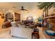 Comfortable living room featuring a stone fireplace, bar area, and stylish decor at 8120 W Red Coach Ave, Las Vegas, NV 89129