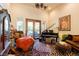 Cozy sitting room features a piano, comfortable seating, and access to the outdoor area at 8120 W Red Coach Ave, Las Vegas, NV 89129