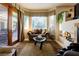 Bright living room with a fireplace, comfortable seating, and views of the outdoor patio and garden at 8120 W Red Coach Ave, Las Vegas, NV 89129