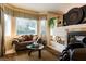 Cozy living room with a fireplace, plush seating, and large windows offering natural light at 8120 W Red Coach Ave, Las Vegas, NV 89129