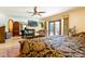 Spacious bedroom features a fireplace, sitting area, and doors leading to the outdoor pool area at 8120 W Red Coach Ave, Las Vegas, NV 89129
