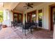 Covered patio with outdoor seating overlooks the pool and greenery, perfect for relaxation at 8120 W Red Coach Ave, Las Vegas, NV 89129