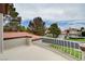 Enjoy neighborhood views from this home's balcony with white decorative railings at 8224 Horseshoe Bend Ln, Las Vegas, NV 89113