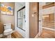 Modern bathroom featuring a glass-enclosed shower, wood-look floors, and stylish wall art at 8224 Horseshoe Bend Ln, Las Vegas, NV 89113