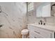 Stylish bathroom with white marble style tile, modern fixtures and a glass block window at 8224 Horseshoe Bend Ln, Las Vegas, NV 89113