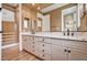 Bathroom features a double vanity with marble countertop and wood-look floors at 8224 Horseshoe Bend Ln, Las Vegas, NV 89113