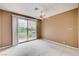 This bedroom features a ceiling fan and sliding glass doors that lead to a balcony at 8224 Horseshoe Bend Ln, Las Vegas, NV 89113