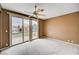 This bedroom features a ceiling fan and sliding glass doors leading to a balcony at 8224 Horseshoe Bend Ln, Las Vegas, NV 89113
