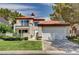Charming two-story home featuring a red tile roof, balcony, and a well-manicured lawn at 8224 Horseshoe Bend Ln, Las Vegas, NV 89113