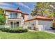 Charming two-story home with a red tile roof, manicured lawn, and white fence and gate at 8224 Horseshoe Bend Ln, Las Vegas, NV 89113