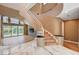 Elegant foyer features a curved staircase, marble flooring, and access to the living spaces at 8224 Horseshoe Bend Ln, Las Vegas, NV 89113