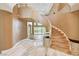 Grand foyer with a curved staircase, marble floors, and high ceilings at 8224 Horseshoe Bend Ln, Las Vegas, NV 89113