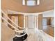 Spacious foyer with marble floors, a curved staircase, and views of the front entrance at 8224 Horseshoe Bend Ln, Las Vegas, NV 89113