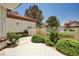 Tiled front patio with manicured landscaping leading to the home's entrance at 8224 Horseshoe Bend Ln, Las Vegas, NV 89113