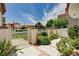 Landscaped front yard with tiled walkway and white fence and gate leading to the home at 8224 Horseshoe Bend Ln, Las Vegas, NV 89113