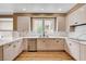 Updated kitchen has white cabinets, quartz counters, and stainless appliances at 8224 Horseshoe Bend Ln, Las Vegas, NV 89113
