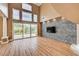 Bright living room with large windows, wood floors, and a stone accent wall at 8224 Horseshoe Bend Ln, Las Vegas, NV 89113