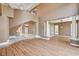 Open-concept living area with a staircase, wood floors, and architectural columns at 8224 Horseshoe Bend Ln, Las Vegas, NV 89113