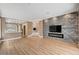 Open living space with stone accent wall, fireplace, and views into the kitchen at 8224 Horseshoe Bend Ln, Las Vegas, NV 89113