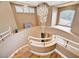 Curved staircase with a chandelier, arched windows, and display ledges at 8224 Horseshoe Bend Ln, Las Vegas, NV 89113