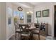 Bright and airy dining room with a view of the outdoors and a decorative accent cabinet at 890 Kitty Hawk Dr # 2412, Mesquite, NV 89027