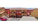 A view of the building with red and yellow accents, and desert landscaping at 890 Kitty Hawk Dr # 2412, Mesquite, NV 89027