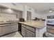 Stylish kitchen with stainless appliances and granite countertops overlooking the living room at 890 Kitty Hawk Dr # 2412, Mesquite, NV 89027