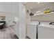 Bright laundry area featuring a full-size washer and dryer with ample shelving for organization at 890 Kitty Hawk Dr # 2412, Mesquite, NV 89027