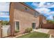 The backyard features a patio area with artificial turf, partially enclosed with a privacy fence at 9031 Jumping Jacks Ave, Las Vegas, NV 89178