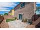 A cozy backyard with a paved patio area, a patch of artificial turf, and a block wall for privacy at 9031 Jumping Jacks Ave, Las Vegas, NV 89178