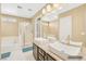 Bright bathroom with double vessel sinks, a walk-in shower, a soaking tub, and tiled floors at 9031 Jumping Jacks Ave, Las Vegas, NV 89178