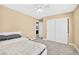 Bedroom with sliding closet doors, neutral walls and carpet, and a view of the en suite bathroom at 9031 Jumping Jacks Ave, Las Vegas, NV 89178