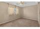 Empty bedroom with neutral walls, carpet flooring, a window, and a ceiling fan at 9031 Jumping Jacks Ave, Las Vegas, NV 89178