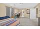 Spacious carpeted bedroom with a bed, desk, and ample space, featuring a window and closet at 9031 Jumping Jacks Ave, Las Vegas, NV 89178