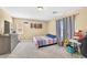 Cozy bedroom with natural light, carpet, a queen bed, and a dresser against a tan wall at 9031 Jumping Jacks Ave, Las Vegas, NV 89178
