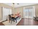 Bright dining area with wood floors, modern lighting, and a wooden table set with a bench and chairs at 9031 Jumping Jacks Ave, Las Vegas, NV 89178