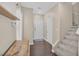 Inviting entryway featuring hardwood floors, staircase, and storage; offers a warm welcome at 9031 Jumping Jacks Ave, Las Vegas, NV 89178