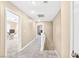Upstairs hallway with neutral carpet leading to bedrooms and featuring a white banister and doors at 9031 Jumping Jacks Ave, Las Vegas, NV 89178
