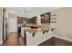 Beautiful kitchen with granite countertops, dark cabinetry, and stainless steel appliances at 9031 Jumping Jacks Ave, Las Vegas, NV 89178