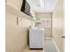 Functional laundry room featuring a washer, shelving, and neutral paint, maximizing space with practical design at 9031 Jumping Jacks Ave, Las Vegas, NV 89178