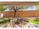Backyard featuring paver patio with firepit and drought tolerant landscaping at 9047 Harbor Wind Ave, Las Vegas, NV 89178