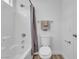 Bright bathroom with a shower/tub combo, modern toilet, and towel racks, complemented by updated fixtures at 9047 Harbor Wind Ave, Las Vegas, NV 89178